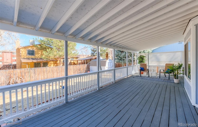 deck with an outdoor structure, a storage shed, and fence