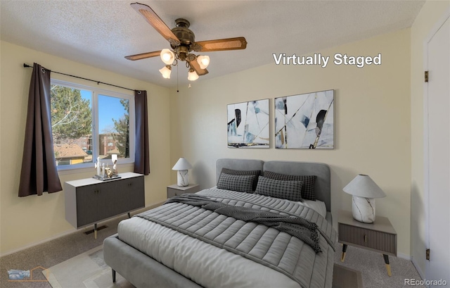 carpeted bedroom featuring ceiling fan, a textured ceiling, and baseboards