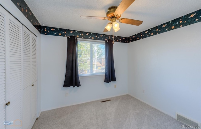 unfurnished bedroom with carpet, a closet, and visible vents