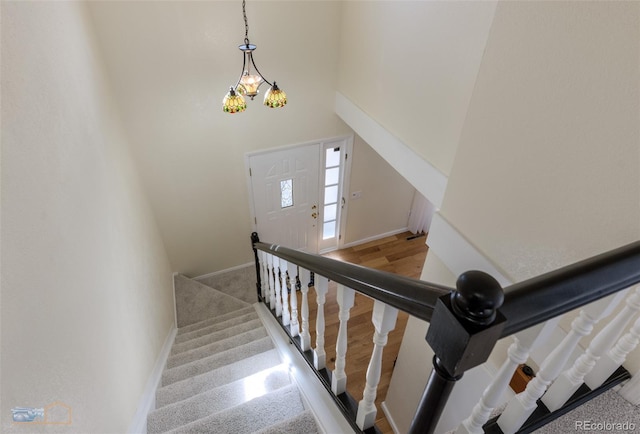 stairs featuring a high ceiling and baseboards