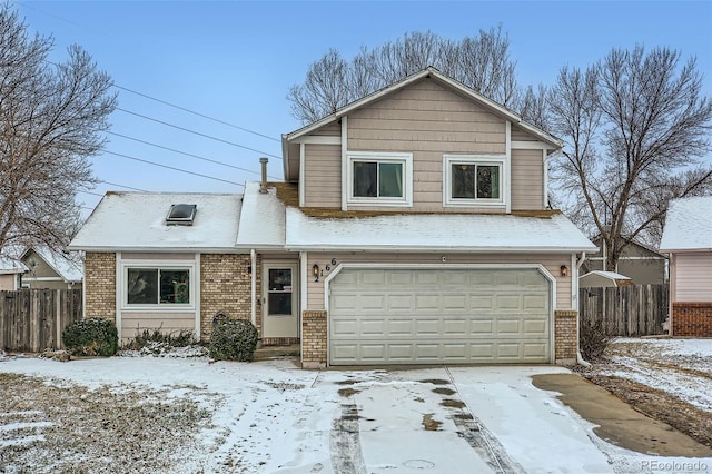 traditional-style house with an attached garage, fence, and brick siding