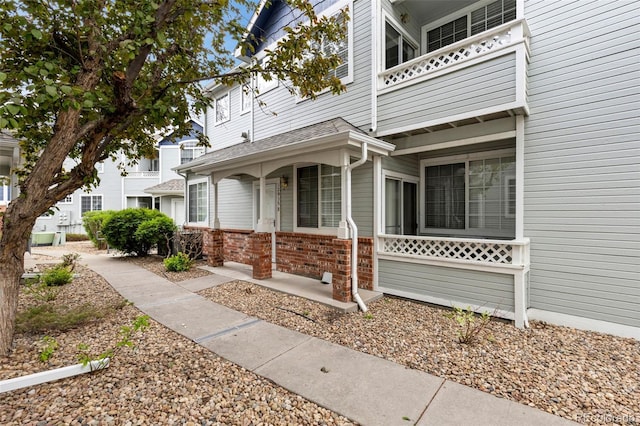 exterior space with brick siding and covered porch