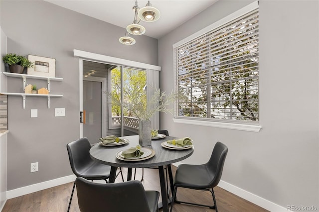 dining room featuring baseboards and wood finished floors