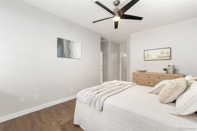 bedroom with baseboards, ceiling fan, and wood finished floors