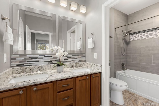 full bathroom with a sink, bathtub / shower combination, toilet, and double vanity