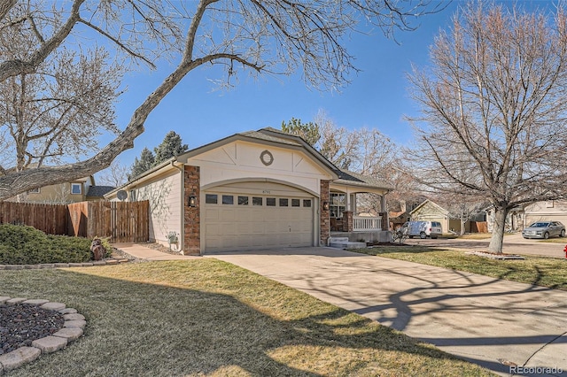 view of front of home with a front lawn, driveway, fence, covered porch, and a garage