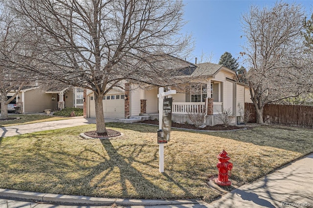 view of front of home with fence, a porch, a front yard, driveway, and an attached garage