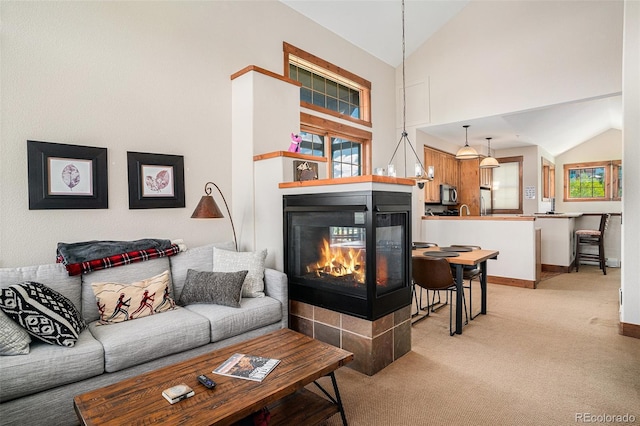 8305 Northstar Unit 8-305, Granby, CO 80446 - living area featuring lofted ceiling, light carpet, a multi sided fireplace, and baseboards