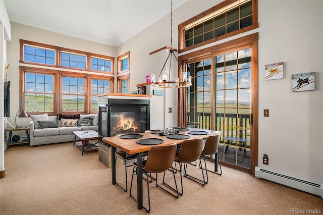 8305 Northstar Unit 8-305, Granby, CO 80446 - carpeted dining space featuring a baseboard heating unit, a glass covered fireplace, and a high ceiling