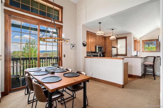 8305 Northstar Unit 8-305, Granby, CO 80446 - dining area with healthy amount of natural light, lofted ceiling, light colored carpet, and baseboards