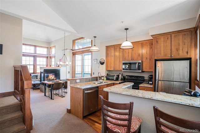 8305 Northstar Unit 8-305, Granby, CO 80446 - kitchen with appliances with stainless steel finishes, a peninsula, light stone counters, a sink, and pendant lighting