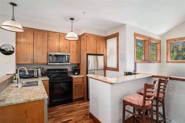 8305 Northstar Unit 8-305, Granby, CO 80446 - kitchen featuring stainless steel appliances, wood finished floors, a sink, light stone countertops, and a breakfast bar area