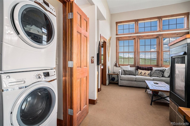 8305 Northstar Unit 8-305, Granby, CO 80446 - laundry room featuring stacked washer / drying machine, light carpet, and baseboards