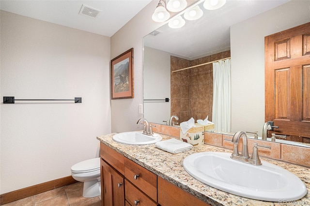 8305 Northstar Unit 8-305, Granby, CO 80446 - bathroom featuring double vanity, toilet, tiled shower, tile patterned flooring, and baseboards