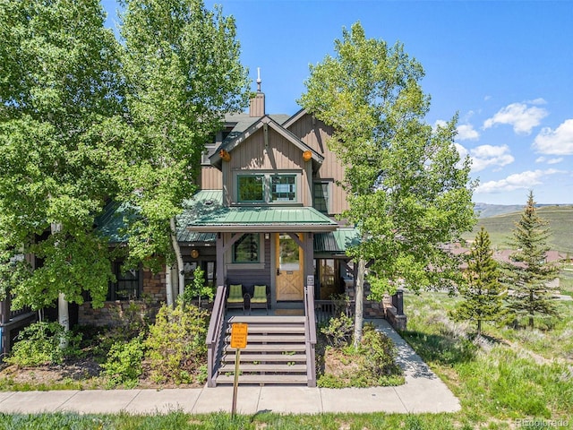 8305 Northstar Unit 8-305, Granby, CO 80446 - view of front of property with a porch, a standing seam roof, a chimney, board and batten siding, and metal roof