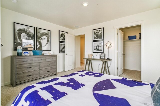 27691 E Byers Ave, Aurora, CO 80018 - bedroom featuring light carpet, a spacious closet, and a closet