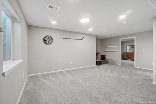 unfurnished living room with light colored carpet