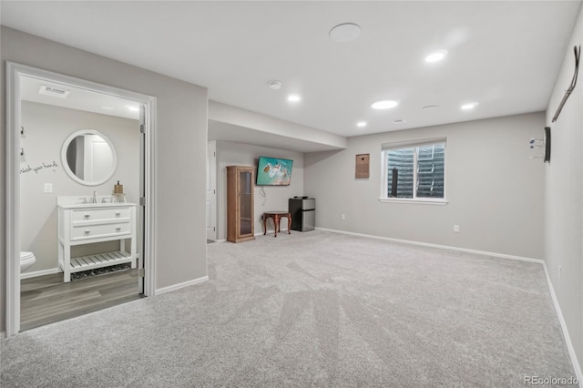 basement with carpet and sink