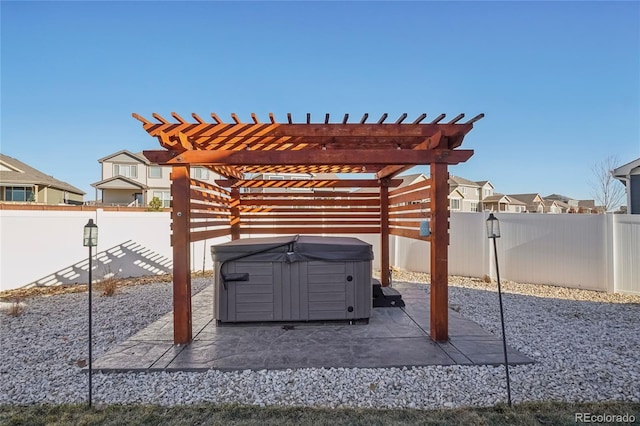 view of patio with a pergola and a hot tub