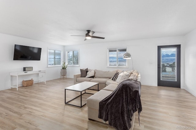 living room featuring ceiling fan and light hardwood / wood-style floors