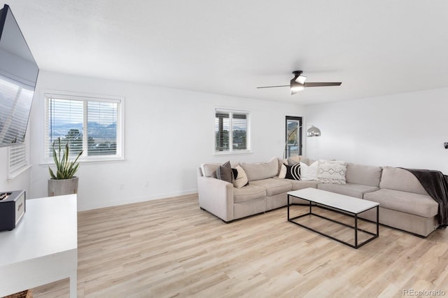 living room featuring ceiling fan and light hardwood / wood-style flooring