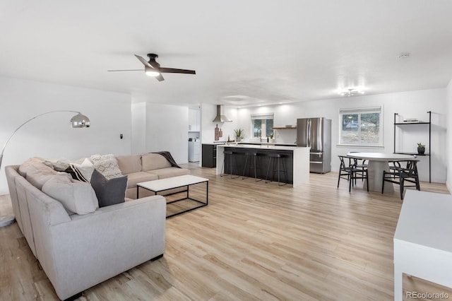 living room with ceiling fan and light hardwood / wood-style floors