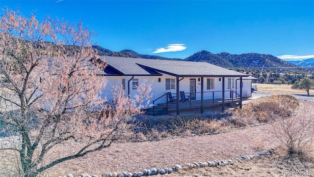 exterior space with a mountain view and a porch