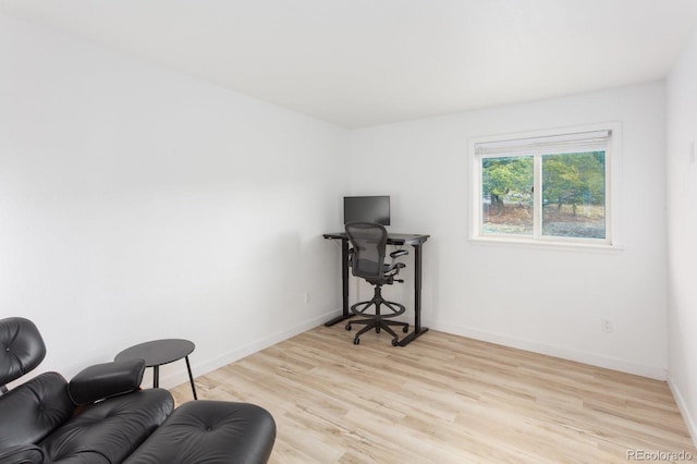 interior space featuring light wood-style flooring and baseboards