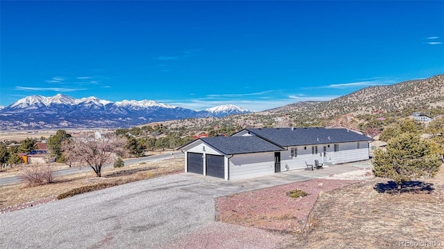 view of front of home featuring a garage and a mountain view