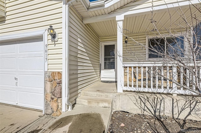 property entrance with a garage and stone siding