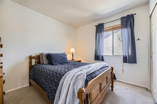 bedroom with light carpet and baseboards