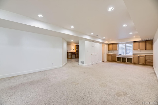 unfurnished living room featuring recessed lighting, light carpet, and baseboards