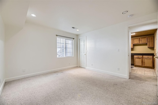 unfurnished bedroom featuring recessed lighting, light carpet, visible vents, baseboards, and a closet