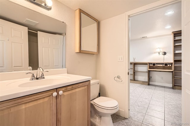 bathroom featuring toilet, tile patterned flooring, vanity, and visible vents