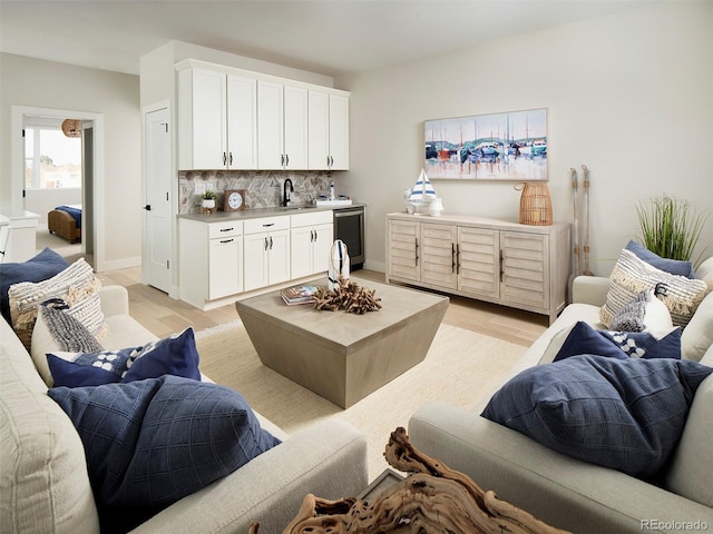 living room featuring sink and light wood-type flooring