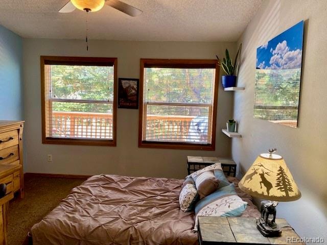 bedroom featuring ceiling fan, carpet, and a textured ceiling