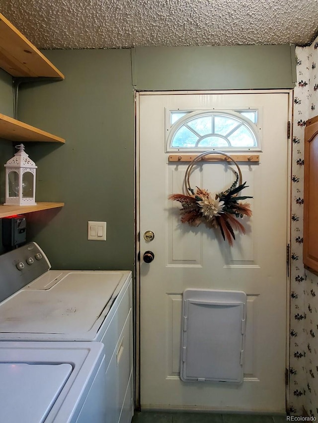 laundry area featuring washer and dryer and a textured ceiling