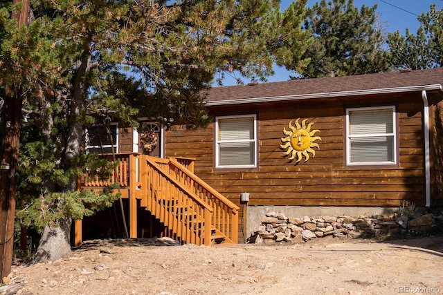 view of side of home with a wooden deck