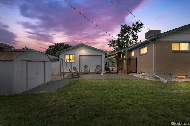 283 Leonard Ln, Northglenn, CO 80233 - back of house with an outdoor structure, a garage, and brick siding