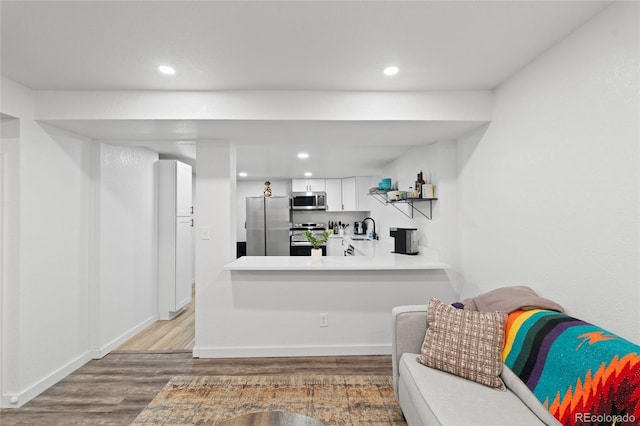 283 Leonard Ln, Northglenn, CO 80233 - kitchen featuring appliances with stainless steel finishes, wood finished floors, recessed lighting, white cabinets, and light countertops