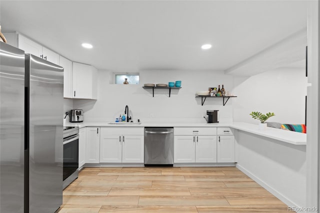 283 Leonard Ln, Northglenn, CO 80233 - kitchen with appliances with stainless steel finishes, open shelves, light wood-style floors, white cabinetry, and light countertops