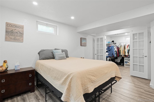 283 Leonard Ln, Northglenn, CO 80233 - bedroom featuring french doors, a spacious closet, light wood-style flooring, a closet, and recessed lighting