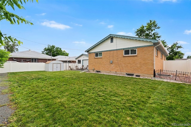 283 Leonard Ln, Northglenn, CO 80233 - back of house featuring brick siding, a storage shed, a fenced backyard, and a patio