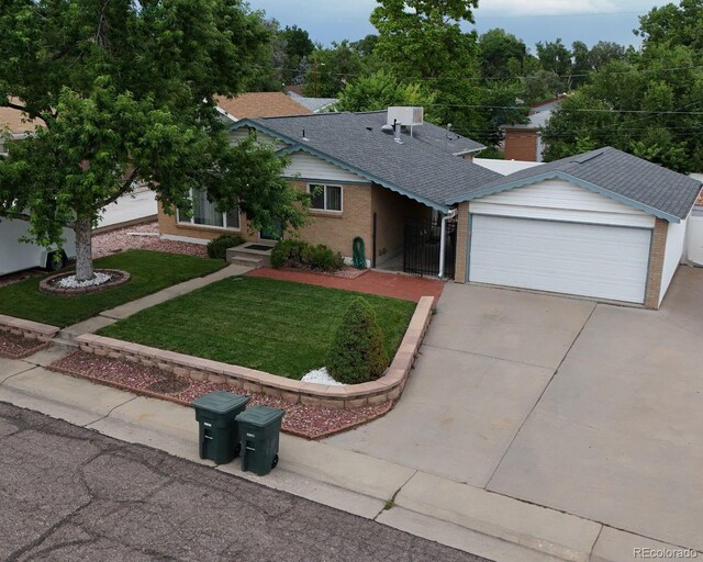 283 Leonard Ln, Northglenn, CO 80233 - single story home with brick siding, concrete driveway, a front yard, a garage, and a shingled roof