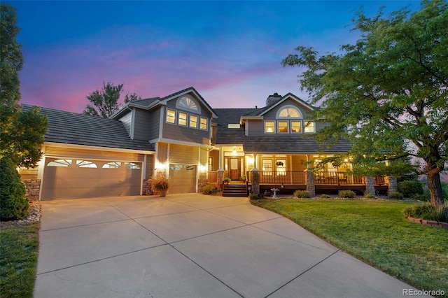 view of front facade with a garage and a lawn