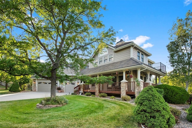 view of front of home featuring a front yard, a porch, and a garage