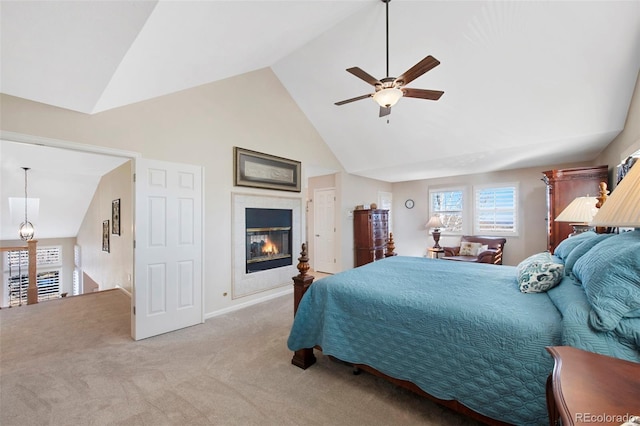 carpeted bedroom with ceiling fan and high vaulted ceiling