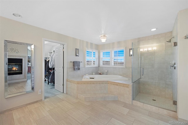 bathroom with tile patterned flooring and separate shower and tub