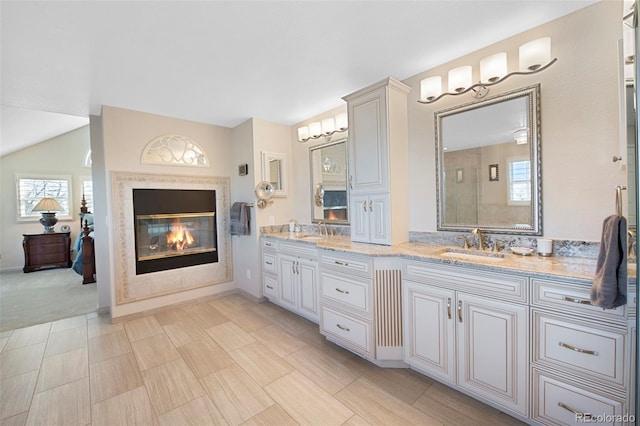 bathroom featuring vanity and lofted ceiling