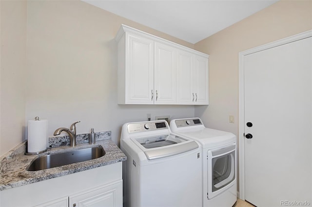 laundry area with cabinets, sink, and washer and dryer